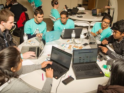 students gathered around their computers